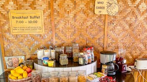 A breakfast buffet setup with various food items and condiments. - Parrot Resort Moalboal (Moalboal)