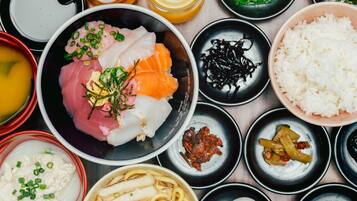 A variety of Japanese dishes including sashimi, rice, and soup.