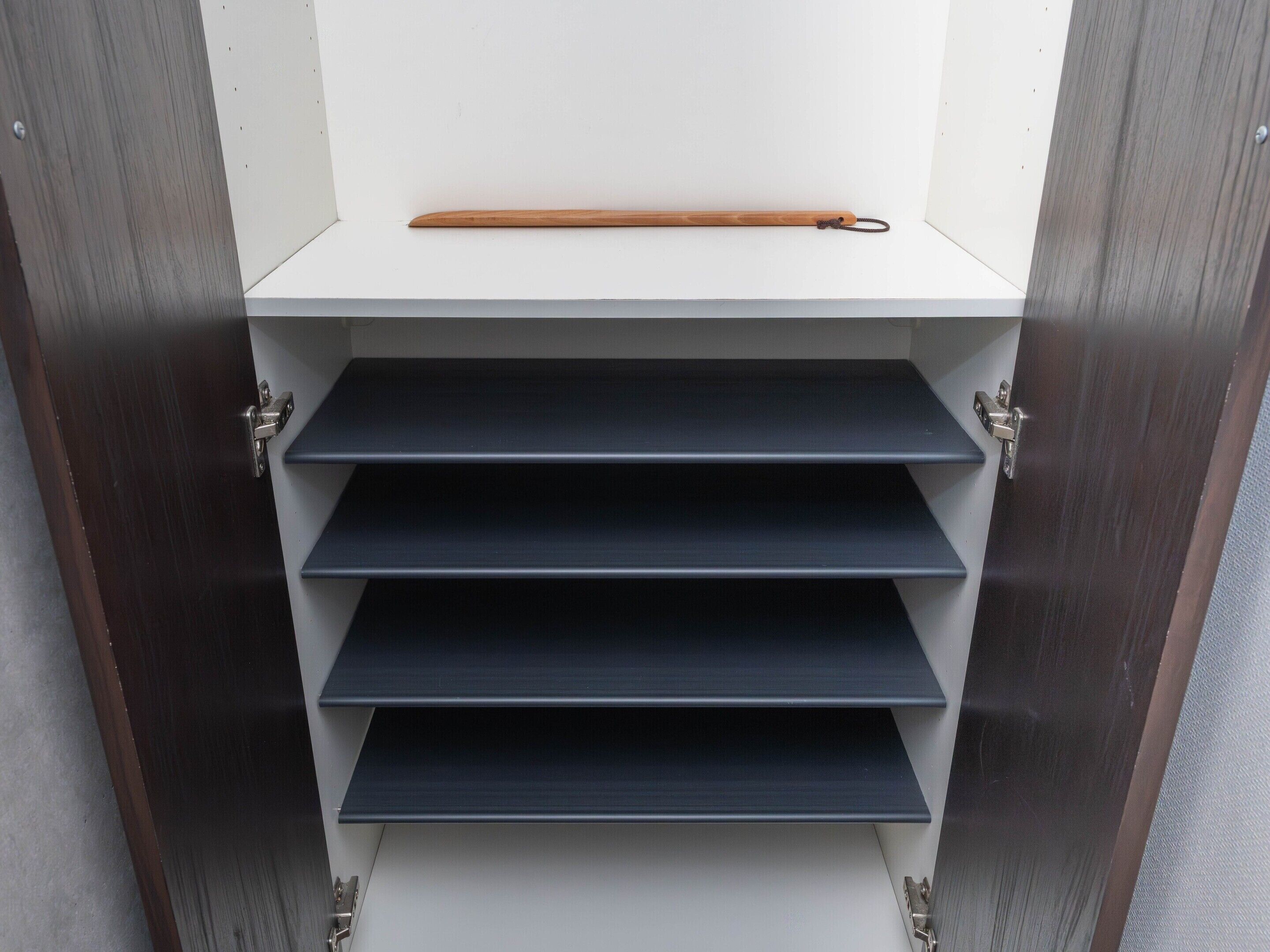 A storage unit with shelves and a wooden stick.