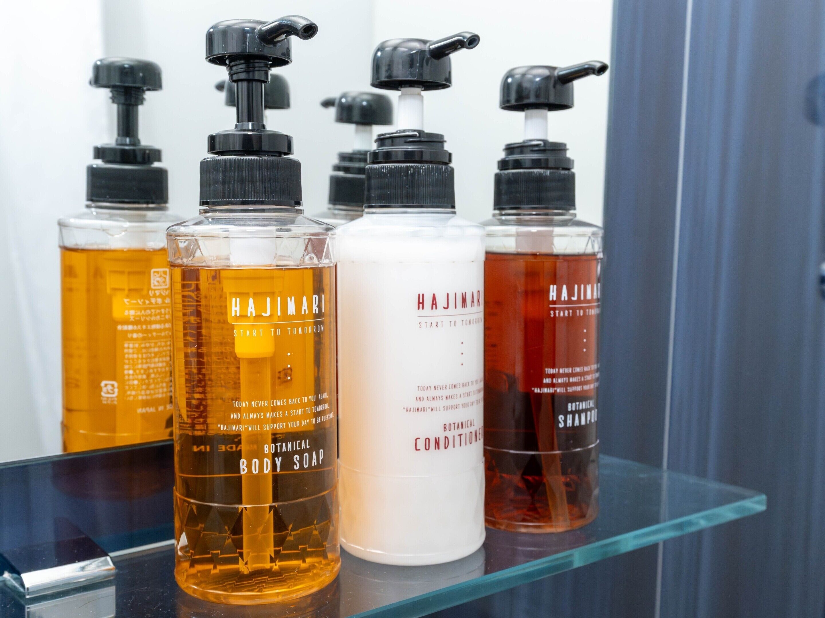 A bathroom shelf with various Hajimari body care products.