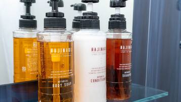 A bathroom shelf with various Hajimari body care products.