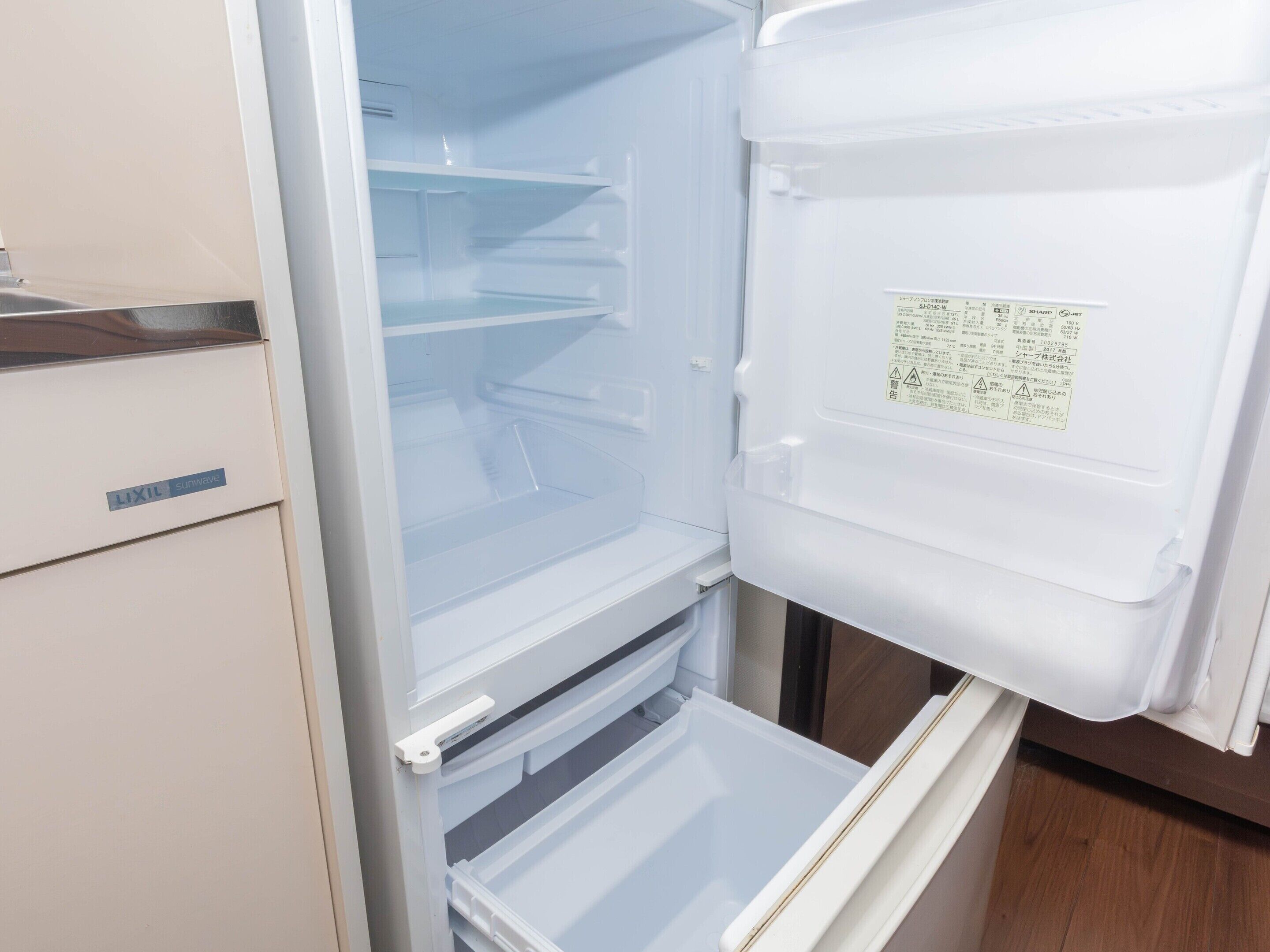 An open refrigerator with multiple shelves and a control panel.