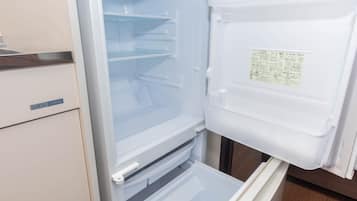 An open refrigerator with multiple shelves and a control panel.