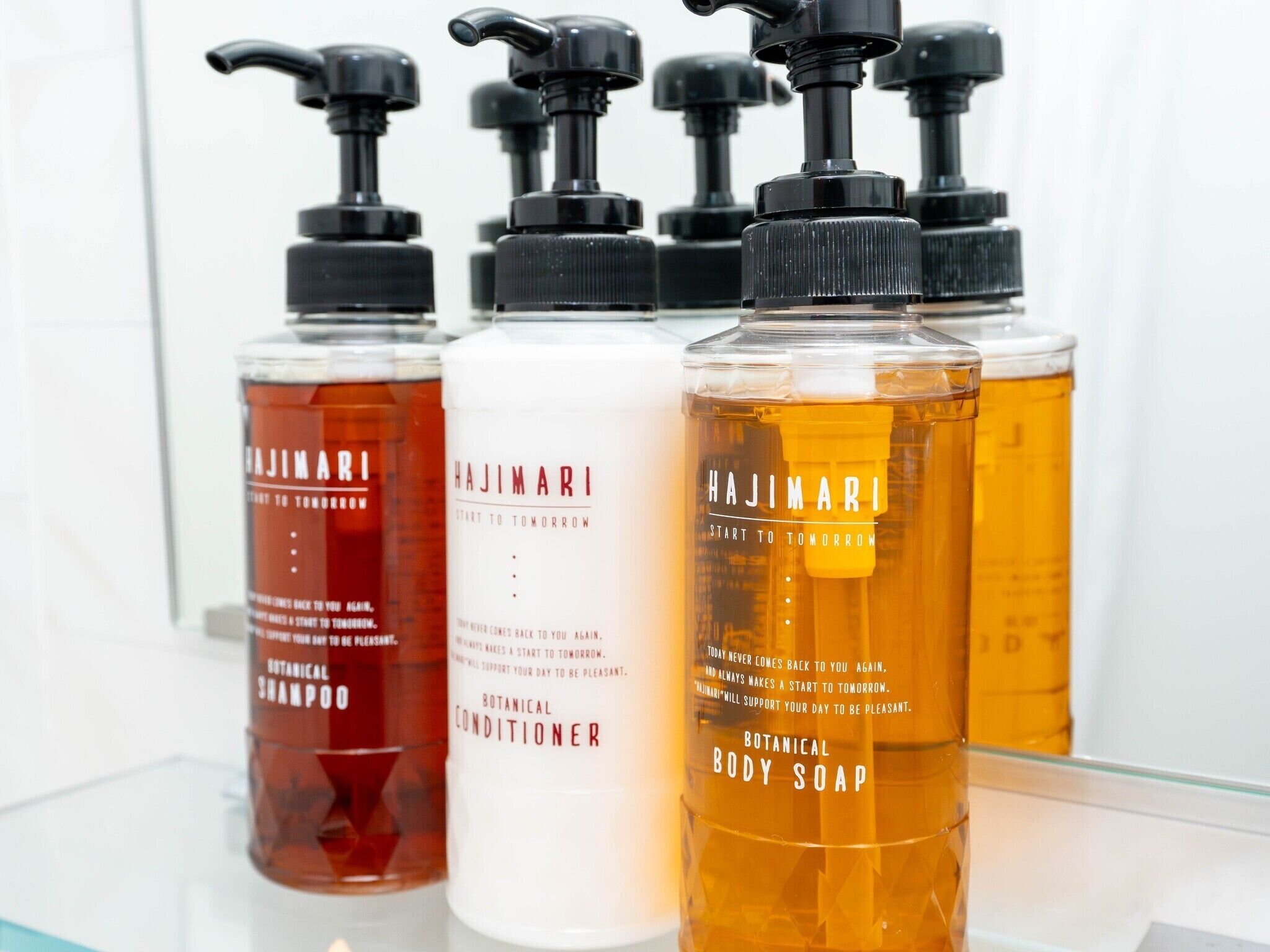 Four bottles of Hajimari body care products.