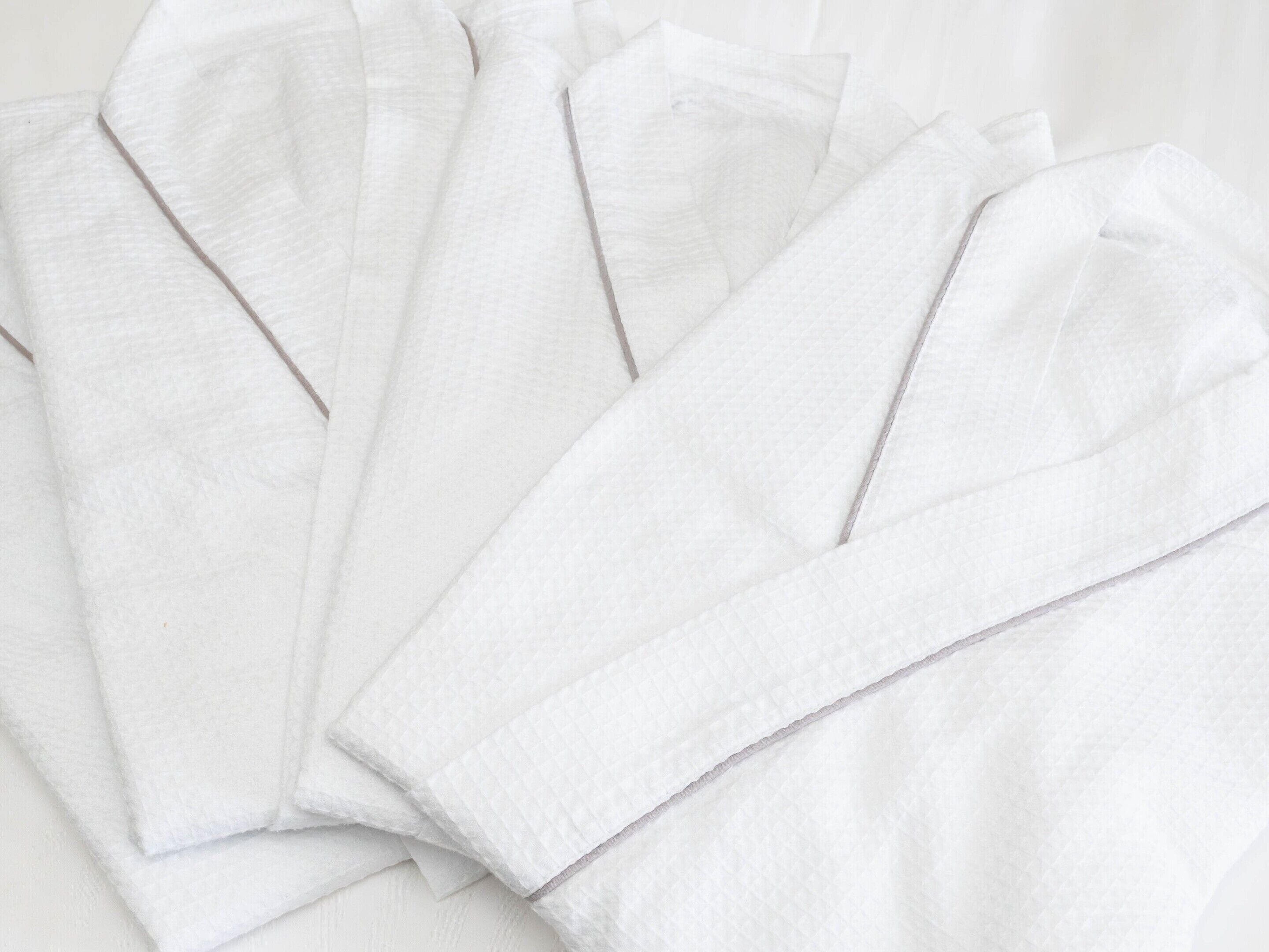 A white, textured fabric with a ribbed pattern, likely a towel or cloth.