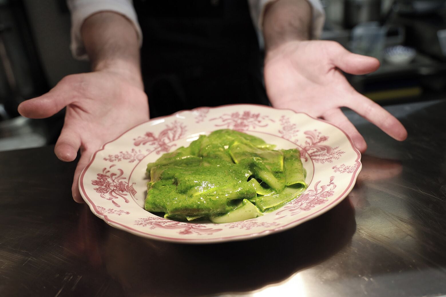 A plate of green food on a table.