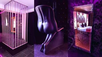 A modern room with a unique chair, a glass partition, and a bed with a patterned headboard.