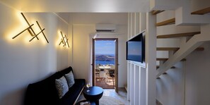 Maisonette Volcano View | Living area | 22-inch flat-screen TV with satellite channels, TV - Astir Thira (Santorini)