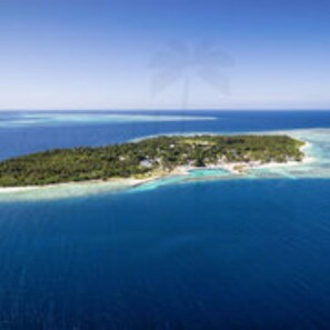 An aerial view of a tropical island with clear turquoise waters, surrounded by a vast ocean. - Feridhoo Inn (Feridhoo)