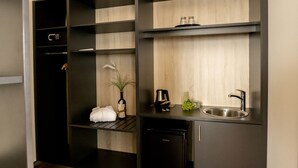 A compact kitchen with a built-in dishwasher, a sink, and a small countertop area. - Hotel Campo (Renningen)