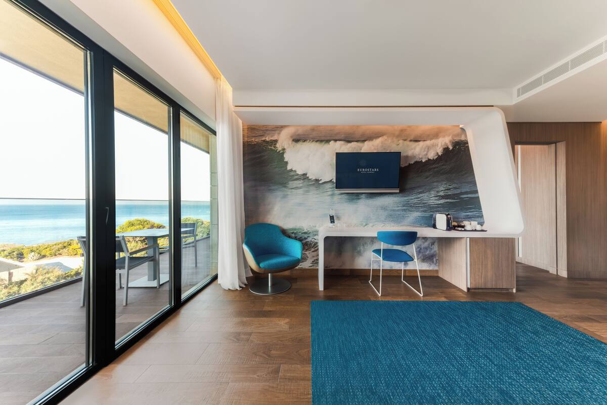 junior suite, sea view | 1 bedroom, in-room safe, individually furnished, desk