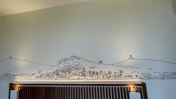 A wall with a black and white cityscape mural.