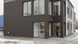 A modern, multi-story building with large windows and a flat roof. - Arcus Premium Hostel (Warsaw)