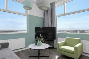Comfort Apartment | Living area | 40-inch TV with satellite channels - Icelandic Apartments by Heimaleiga (Kópavogur)