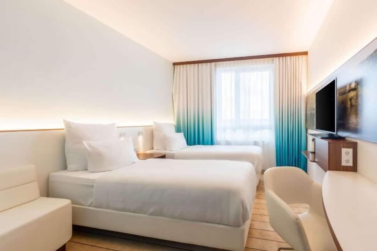 Hypo-allergenic bedding, desk, laptop workspace, blackout curtains