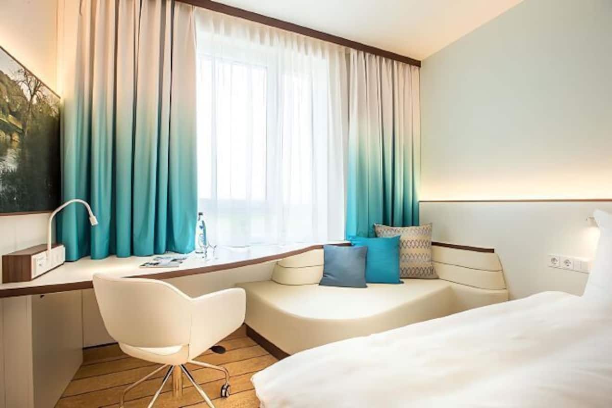 Hypo-allergenic bedding, desk, laptop workspace, blackout curtains