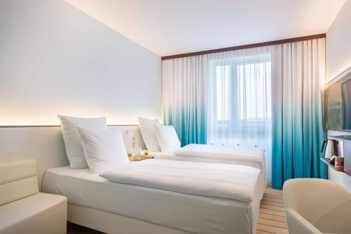 Hypo-allergenic bedding, desk, laptop workspace, blackout curtains