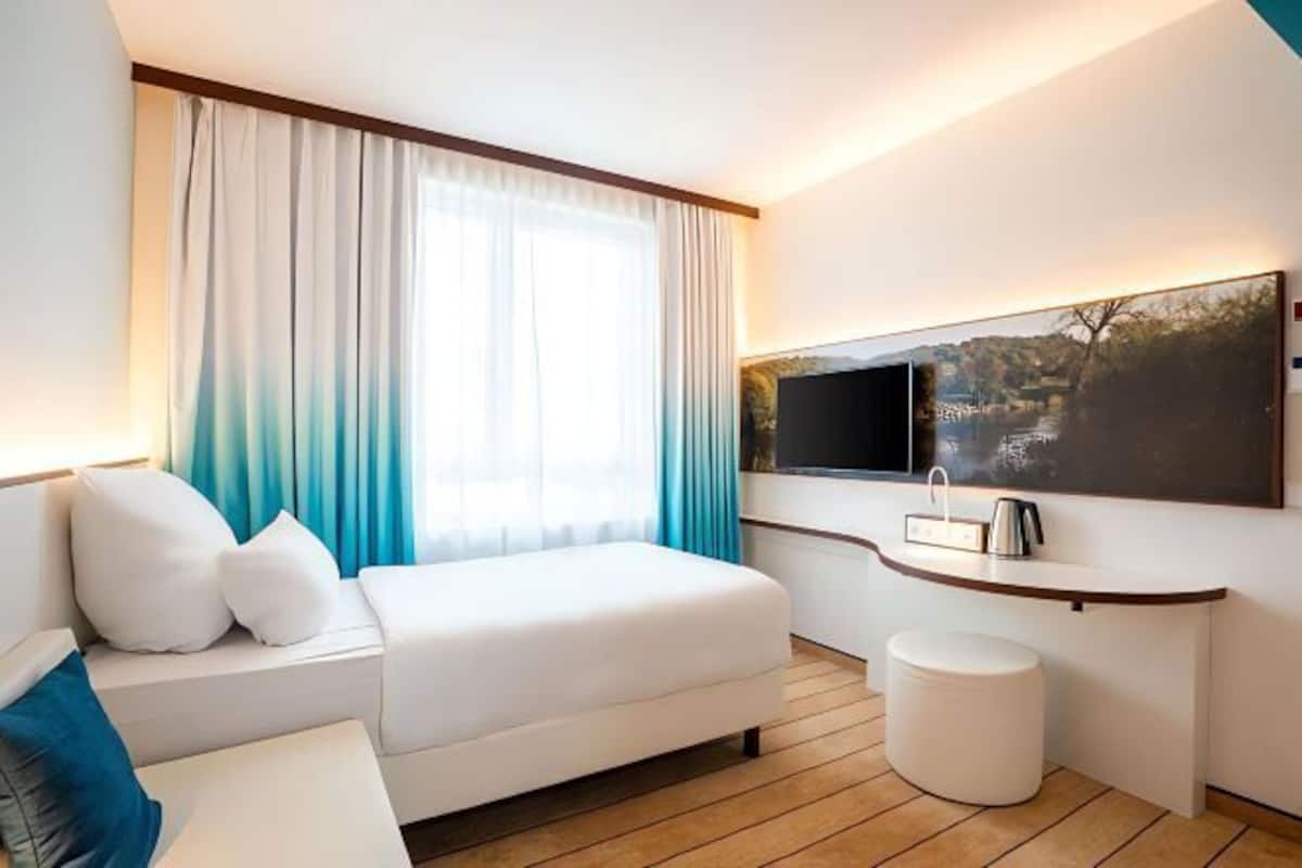 Hypo-allergenic bedding, desk, laptop workspace, blackout curtains