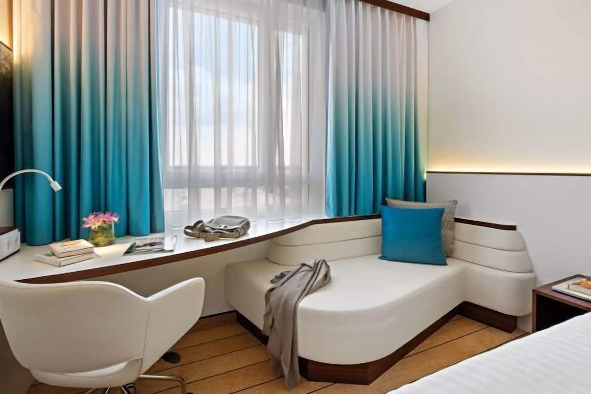 Hypo-allergenic bedding, desk, laptop workspace, blackout curtains