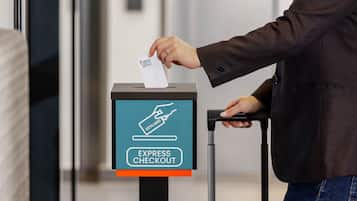 A person using an express checkout machine with a keycard.