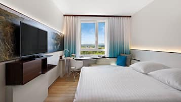 Hypo-allergenic bedding, desk, laptop workspace, blackout drapes