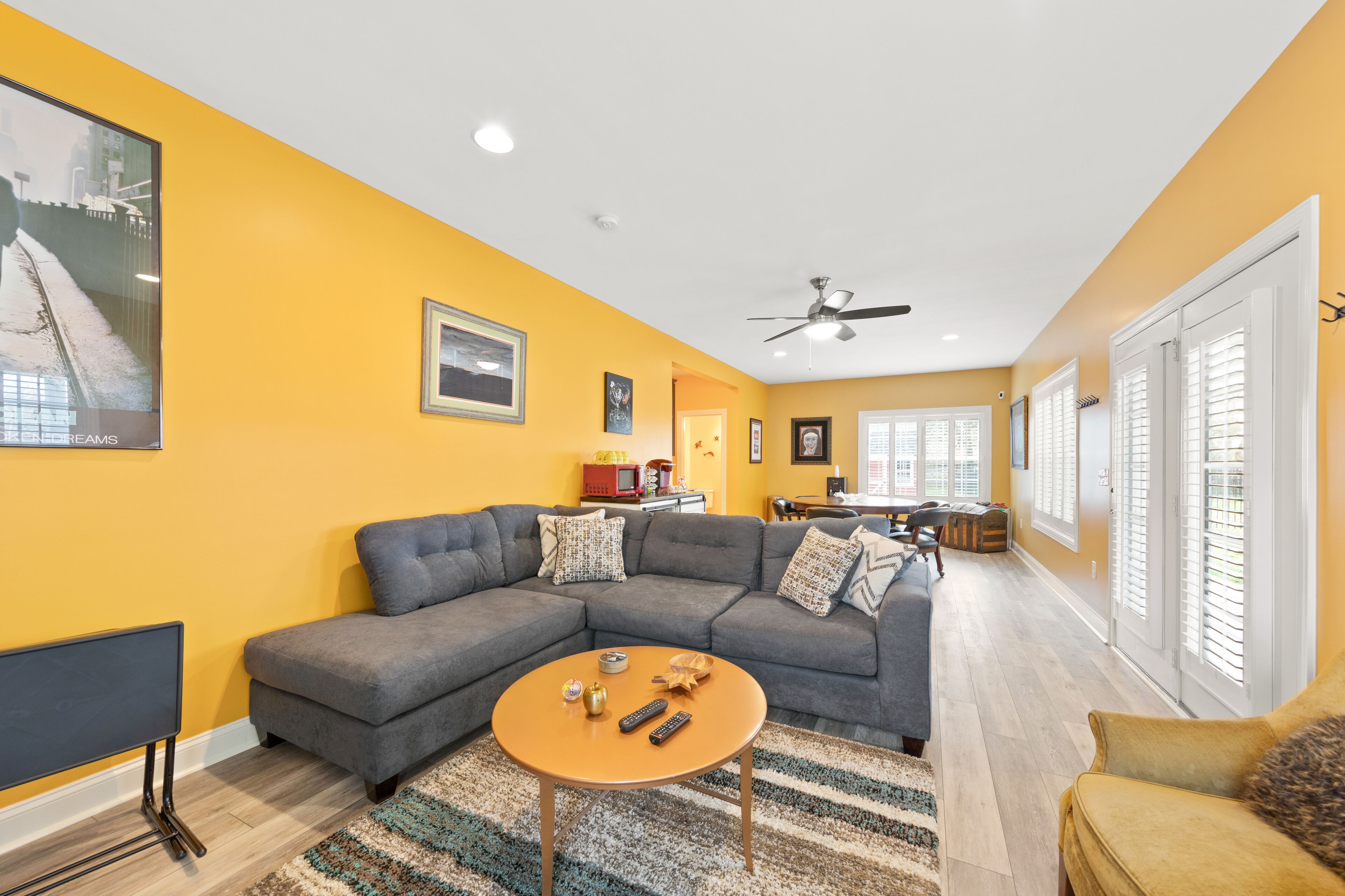 A living room with a sectional sofa, a coffee table, and a TV.