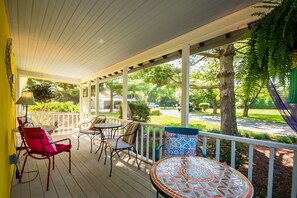 Relax in this serene outdoor space with a seating area featuring a table and chairs.