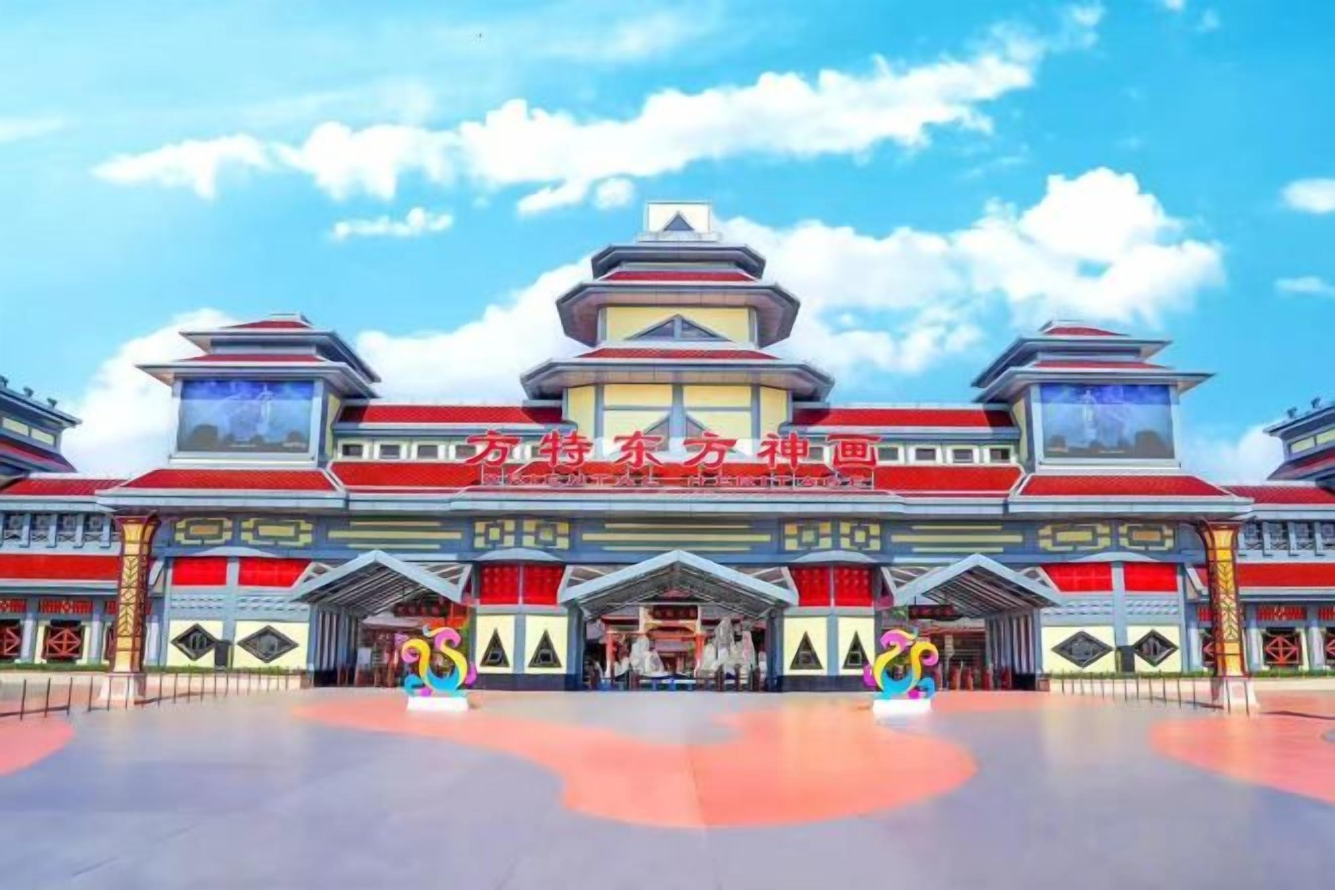 A large building with a traditional architectural style, featuring multiple levels and a prominent central tower.