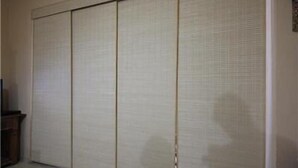 A room with a sliding shoji screen door, a wooden cabinet, and a light-colored floor. - GoHouse Julio 201 (Rio de Janeiro)