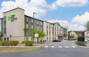 A Stay America hotel with a modern design, multiple floors, and a parking area.