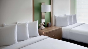 A hotel room with two beds, a bedside table with a lamp, and a telephone. - The Hayes Street Hotel, Trademark Collection by Wyndham (Nashville)