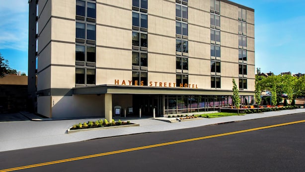 A modern hotel building with a flat facade, large windows, and a clear sky. - The Hayes Street Hotel, Trademark Collection by Wyndham (Nashville)