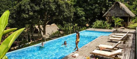 Alberca al aire libre y camastros