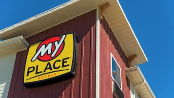 A My Place Hotels sign on a red building.