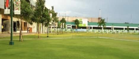 A grassy area with a building in the background.