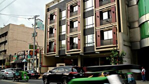 A multi-story building with a modern architectural design, featuring a mix of rectangular and square windows. - Ortigas Budget Hotel - Kapitolyo (Pasig)