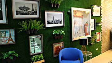 Adorned with a diverse collection of photographs and potted plants, this space offers a culturally rich display.