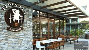 Un gastropub con terraza, paredes de piedra y vistas despejadas del entorno.