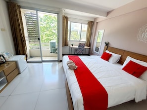 A hotel room with a bed, a desk, a chair, and a view of the outdoors. - The Park Bangyai Residence (Bang Yai)