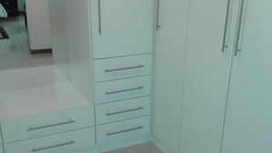A bedroom with a wardrobe, a bed, and a nightstand. - Upper Room Guest House (Francistown)