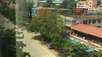A street view with a building featuring a large billboard advertising a restaurant.