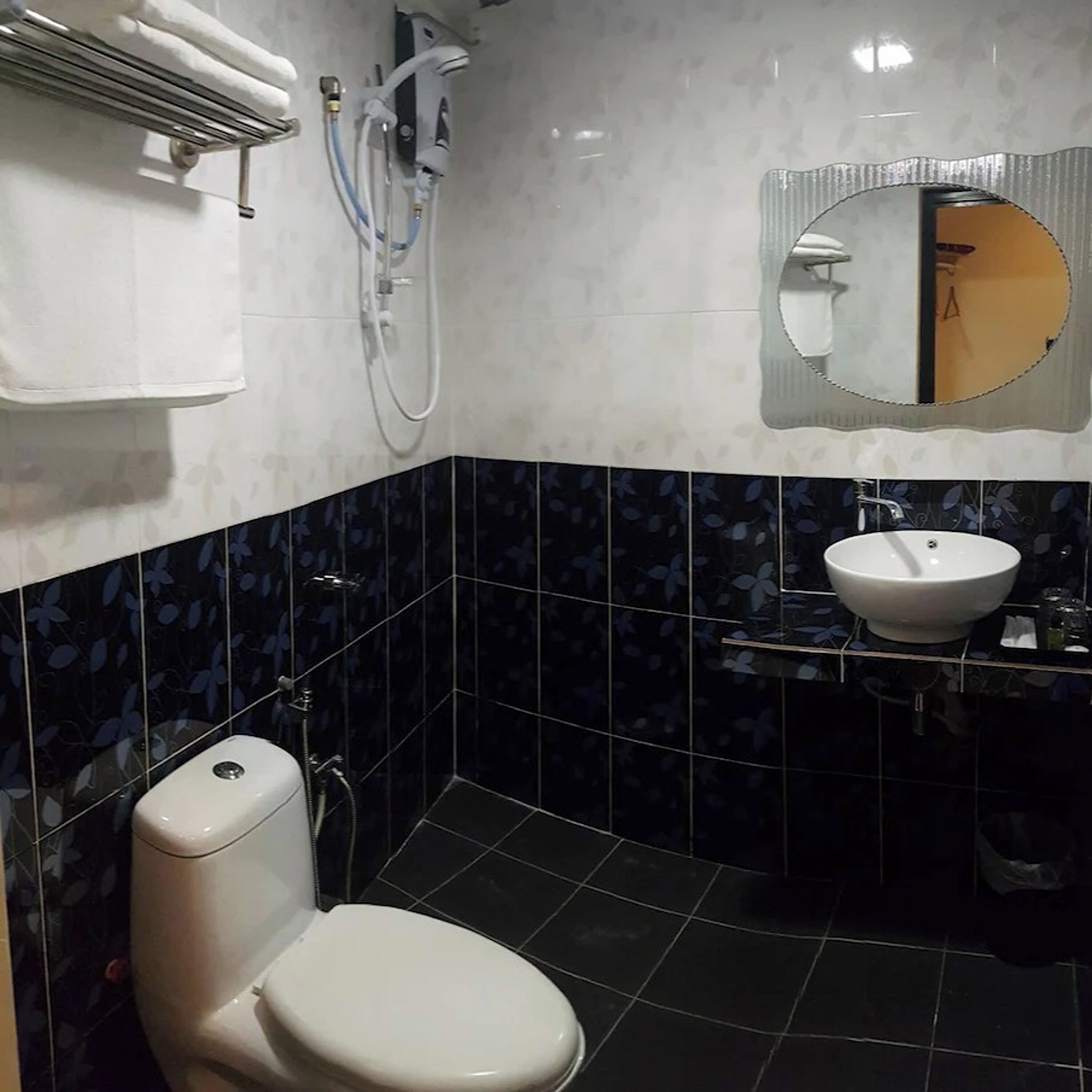 A bathroom with a toilet, a sink, and a shower.