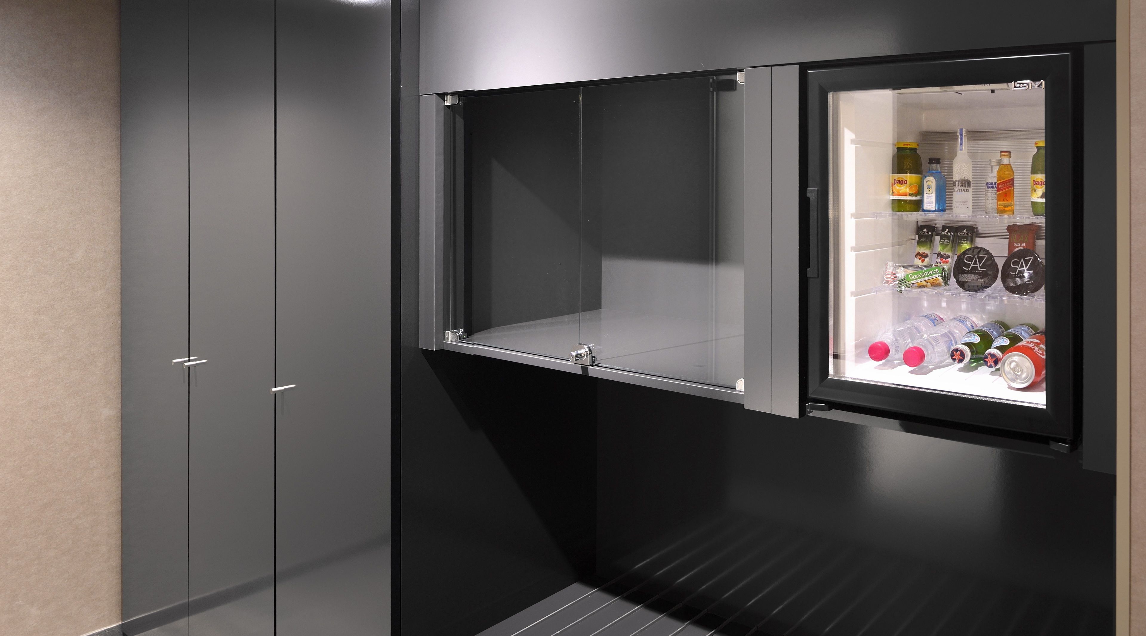 A modern kitchen with a built-in refrigerator and a microwave.