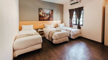 A hotel room with three beds, a painting on the wall, and an air conditioning unit.