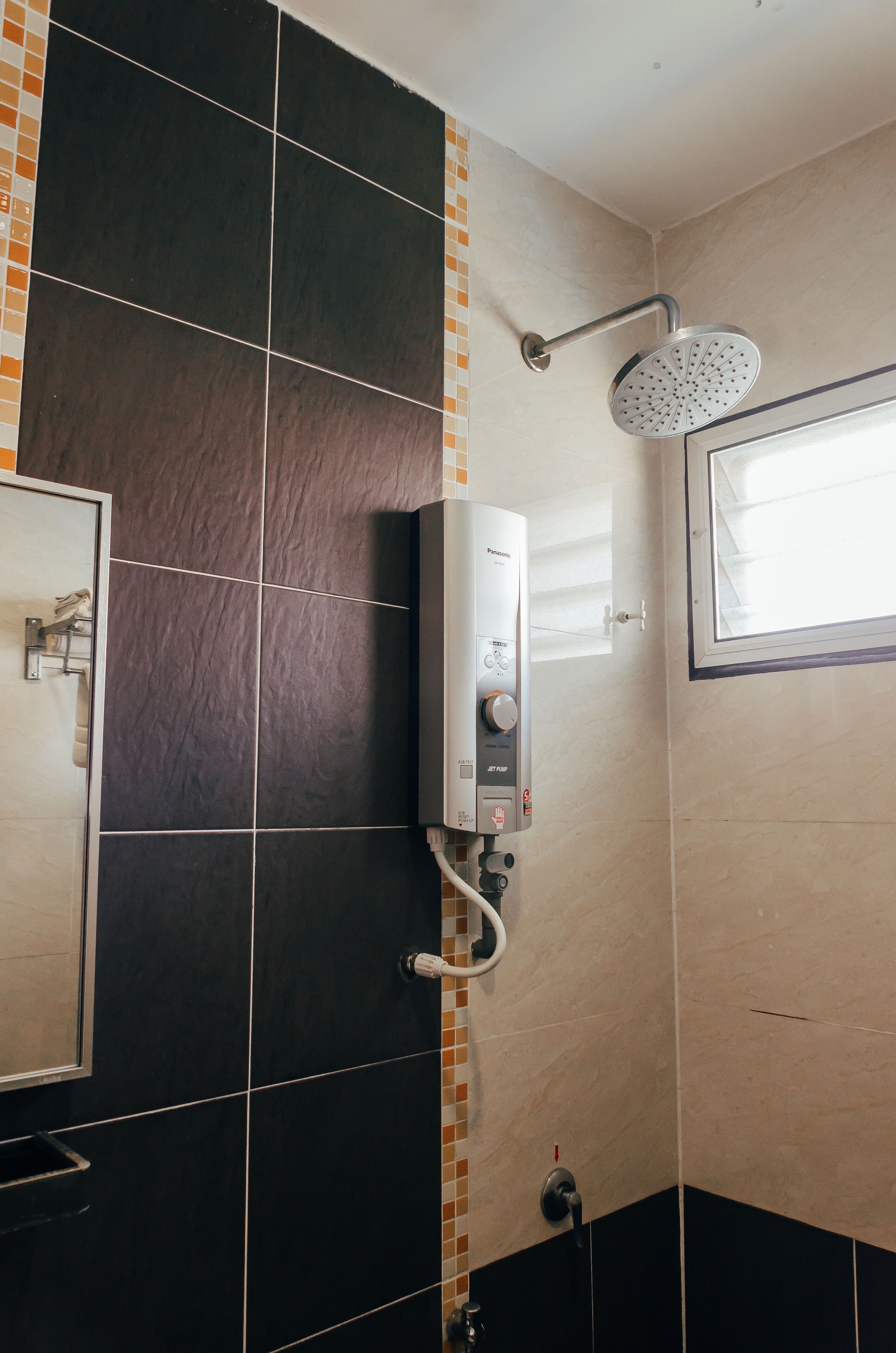 A bathroom with a shower, a toilet, and a sink.