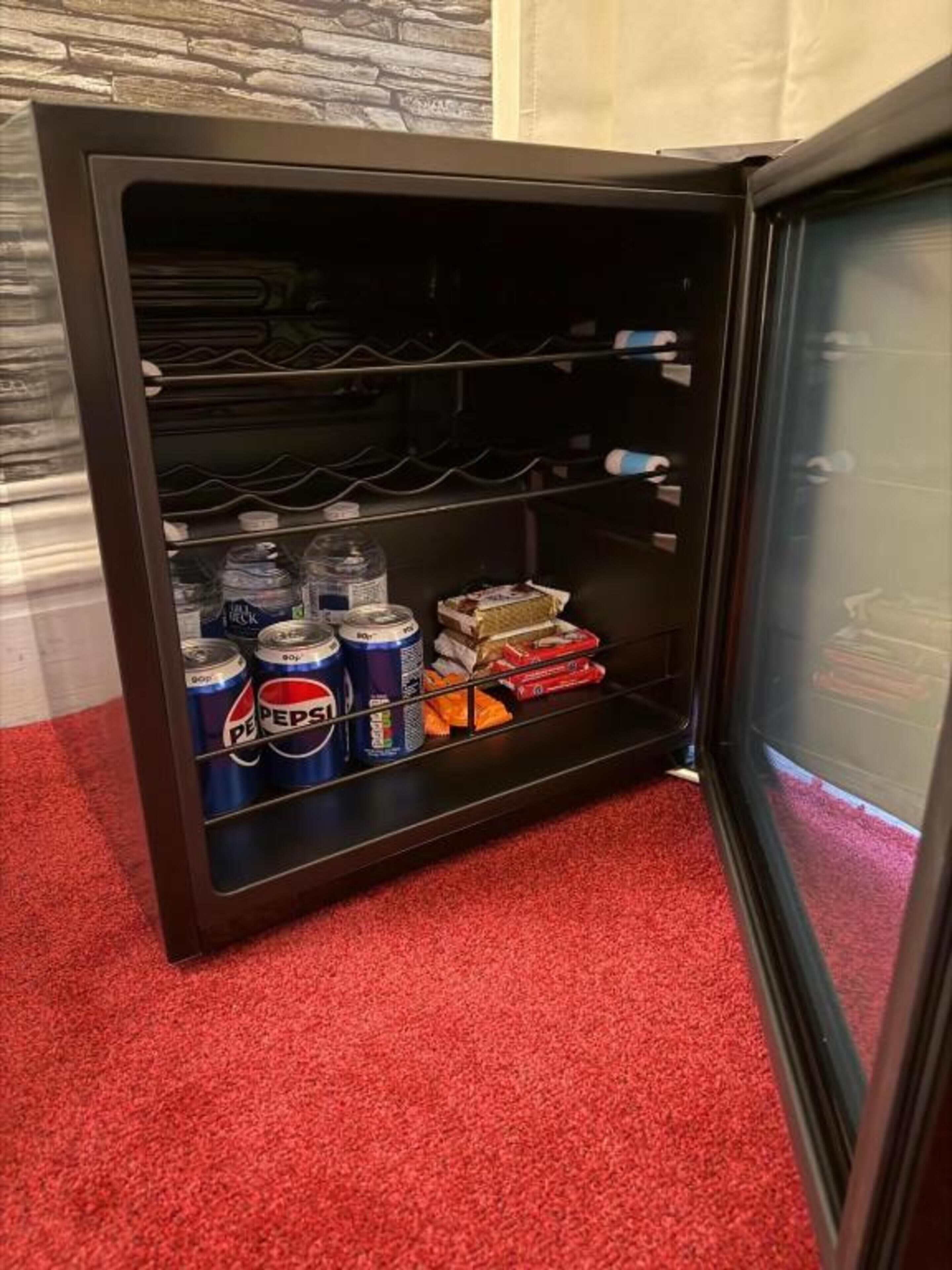 A minibar with beverages and snacks.