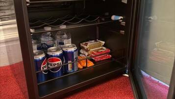 A minibar with beverages and snacks.