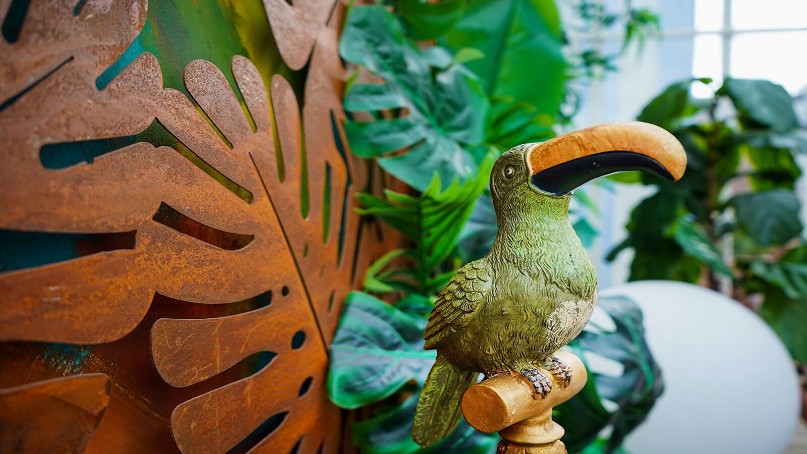 A bird sculpture on a wooden stand.