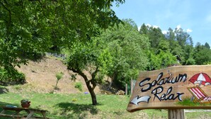 A wooden sign with the text "Solarium Relax" and a beach umbrella illustration. - Dalla Natura la Salute (Giustino)