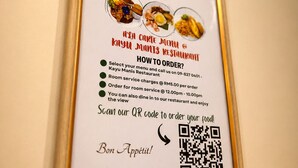 A framed menu with QR code for ordering at KAYU MANIS RESTAURANT.